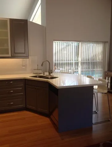 a kitchen with a sink and wooden cabinets