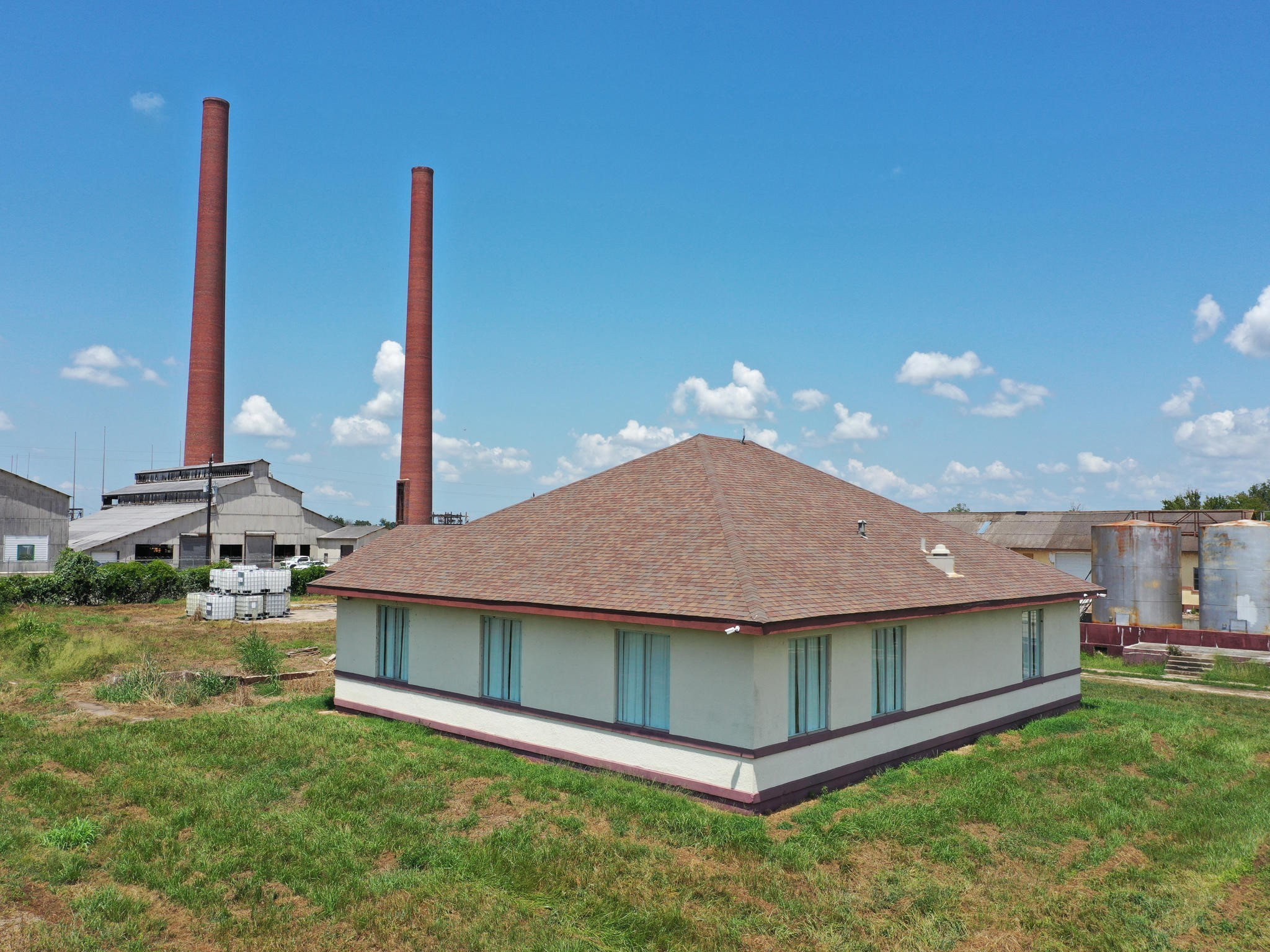 a front view of a house with a garden and yard