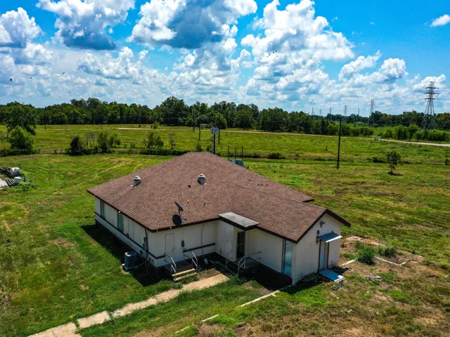 an aerial view of a house with garden space and lake view