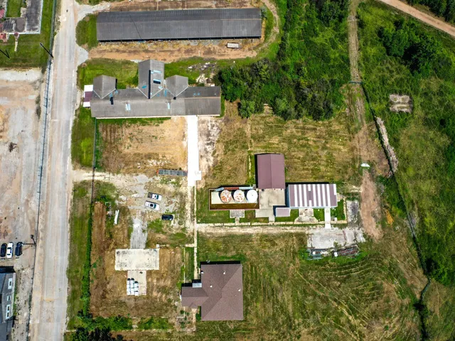 an aerial view of a house with a garden and lake view