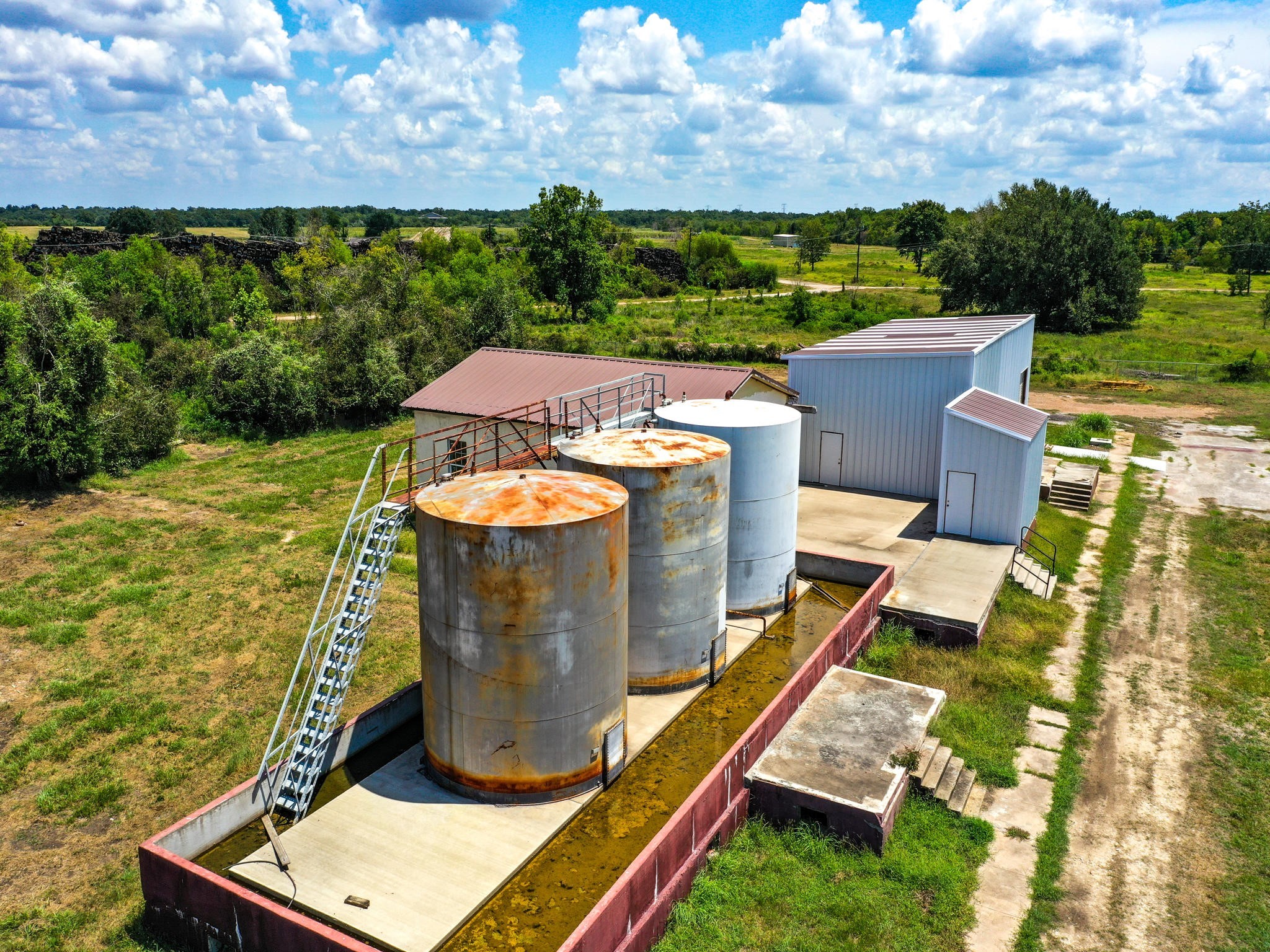 303 Vat Road Boling, TX 77420 - Photo 16 of 31 an aerial view of a house with a garden and lake view