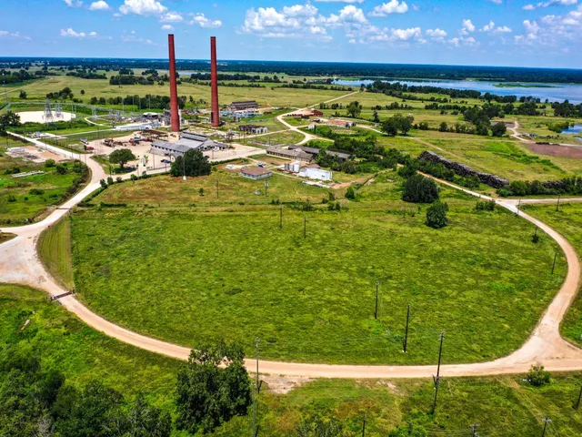 an aerial view of a house with garden space and street view