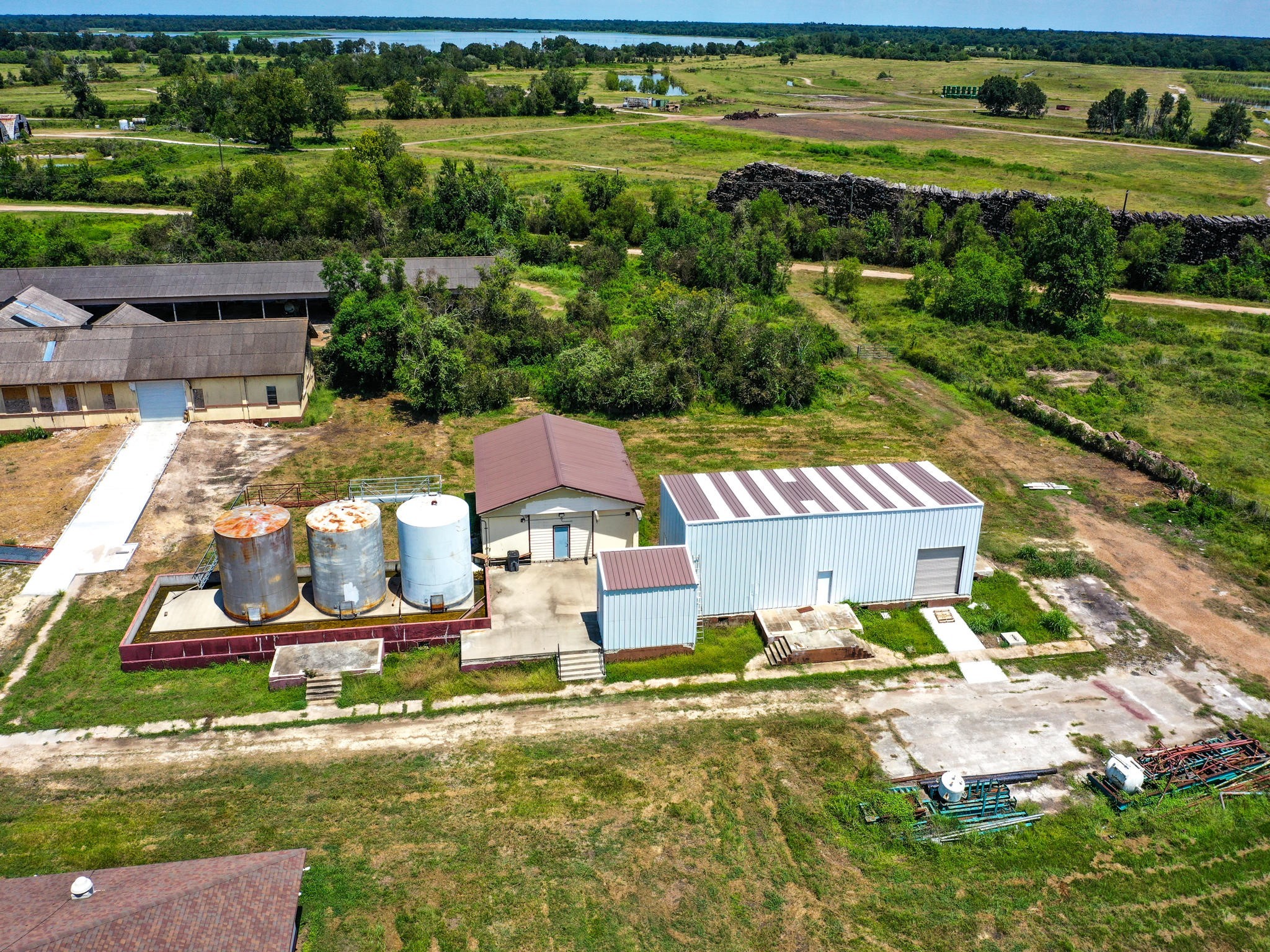 303 Vat Road Boling, TX 77420 - Photo 25 of 31 an aerial view of a house with a garden and lake view