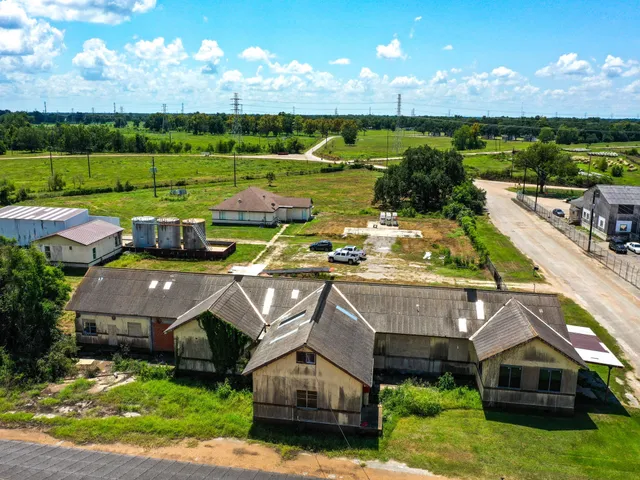 an aerial view of houses with an outdoor space and seating