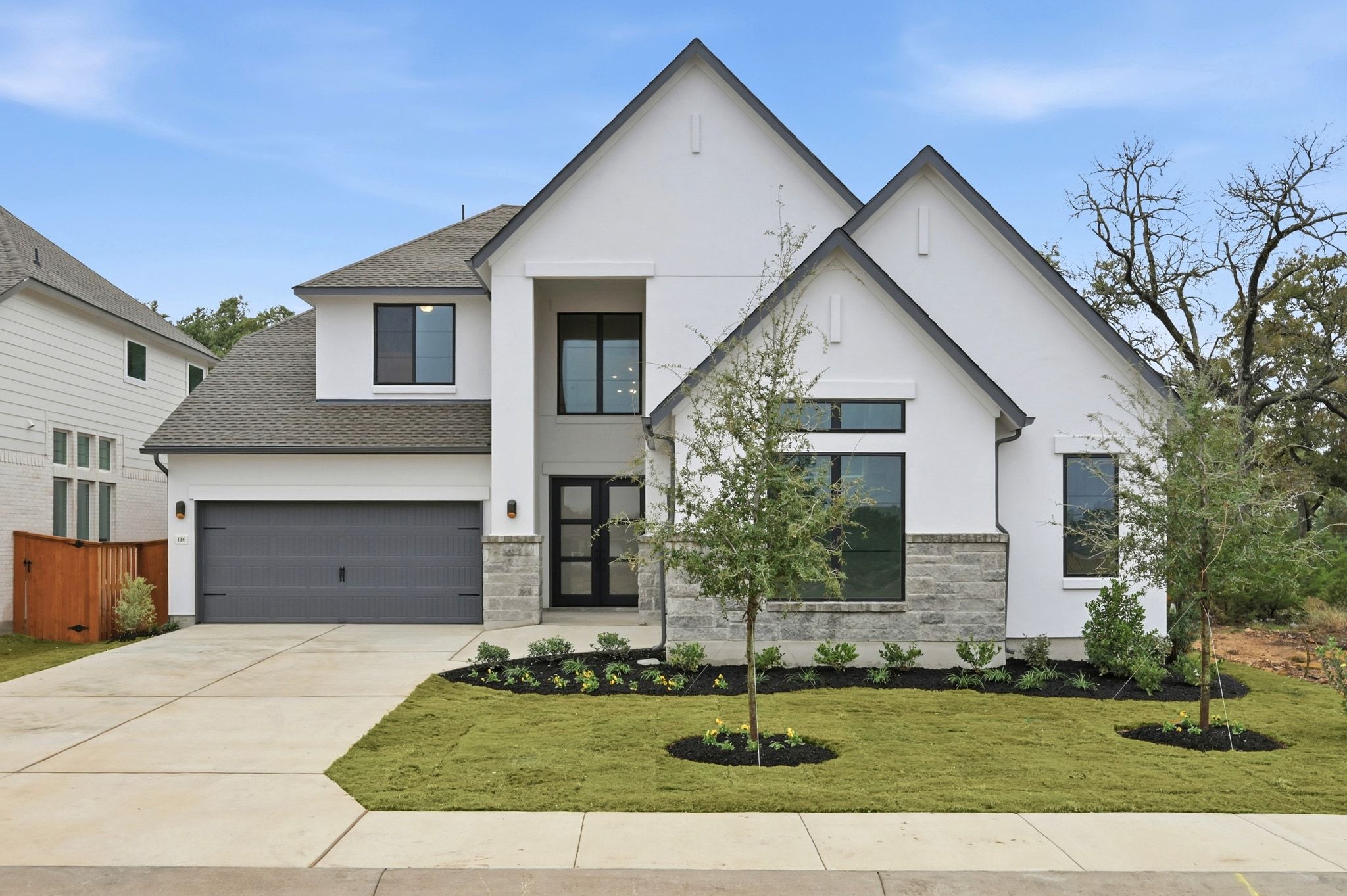 a front view of a house with garden