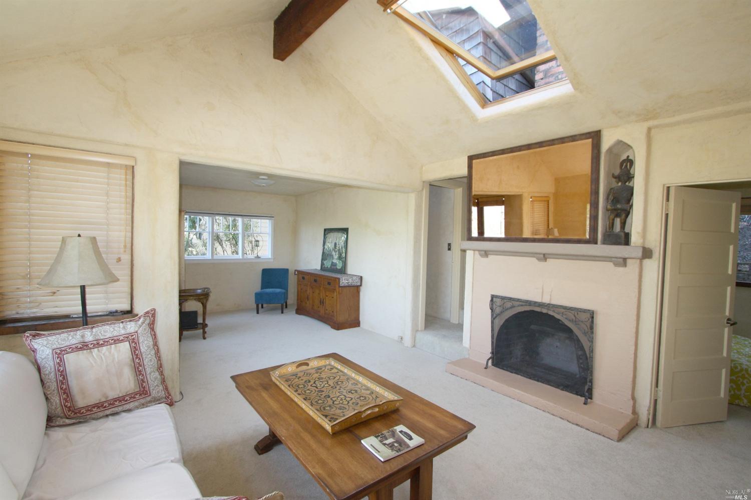 87 Ridge Road Fairfax, CA 94930 - Photo 1 of 1 a living room with furniture and a fireplace