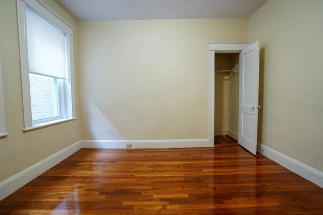 a view of room with window and wooden floor