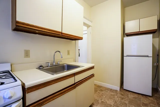 a kitchen with a sink and a refrigerator