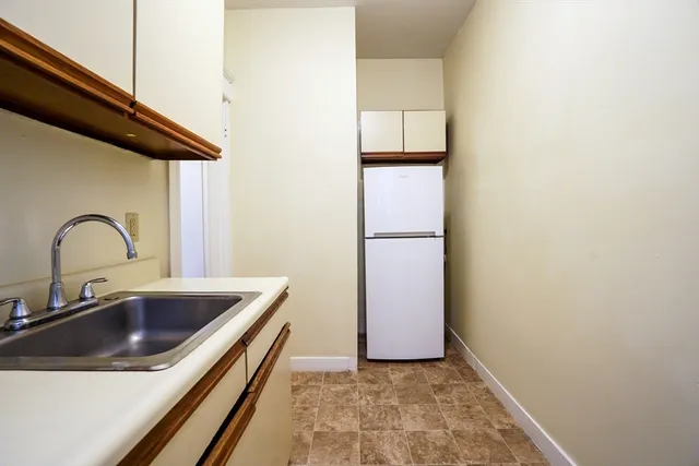 a kitchen with a sink and a refrigerator