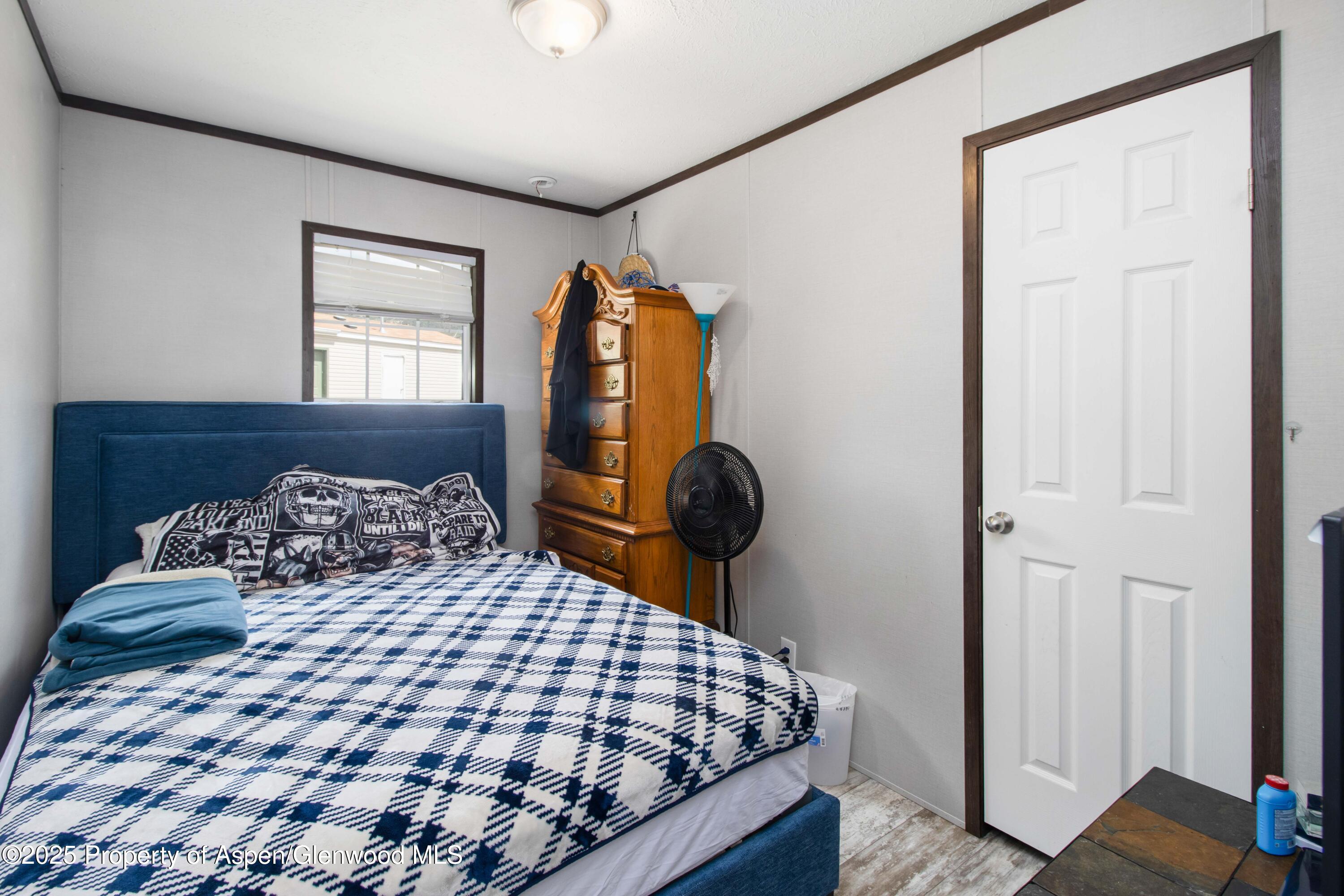 88 West Carson Circle Parachute, CO 81635 - Photo 10 of 18 a bedroom with a bed and wooden floor