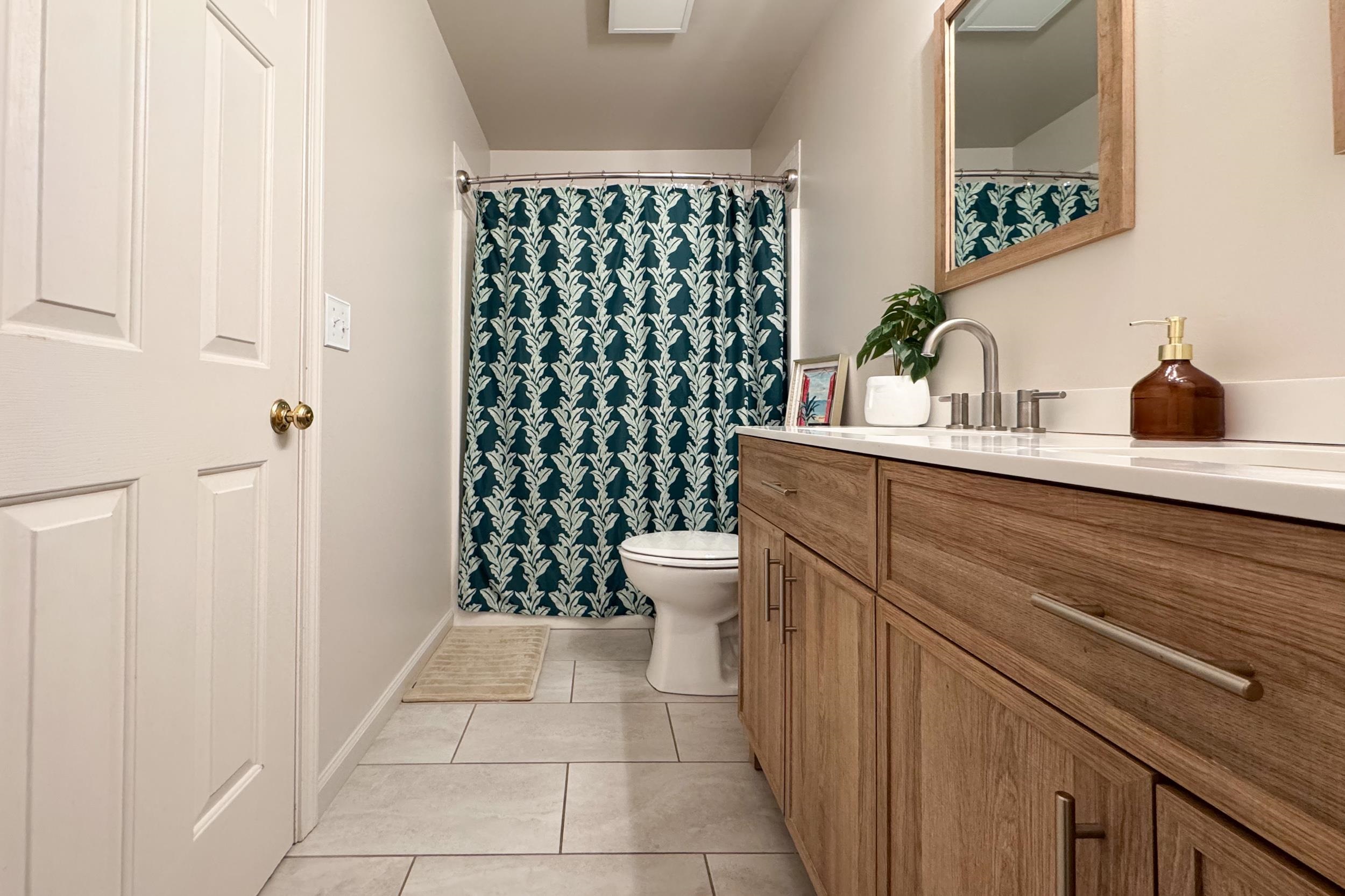 7253 Chucks Way Loves Park, IL 61111 - Photo 21 of 26 a bathroom with a sink a toilet and shower curtain