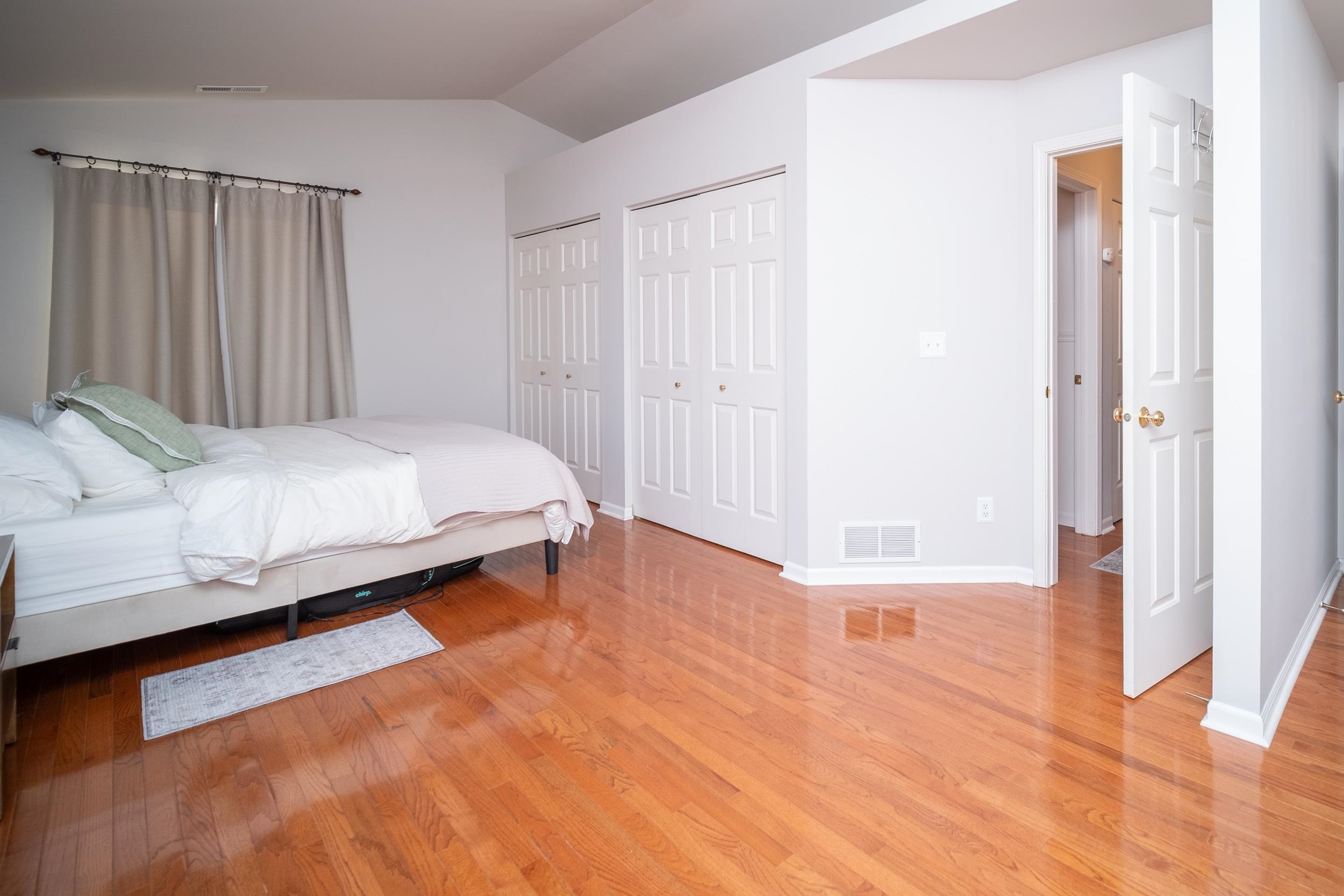 7253 Chucks Way Loves Park, IL 61111 - Photo 23 of 26 a bedroom with a bed and a wooden floor