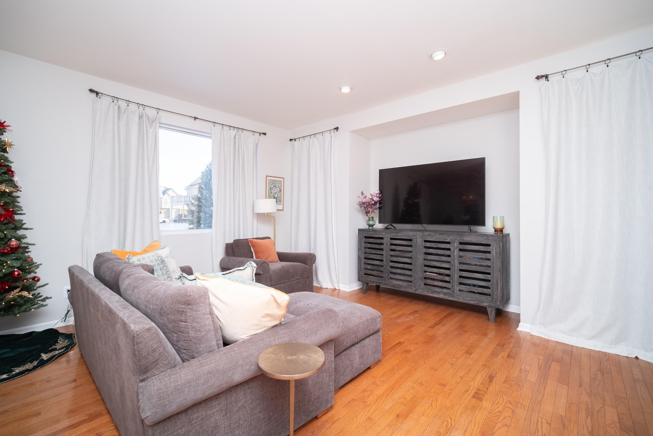 7253 Chucks Way Loves Park, IL 61111 - Photo 6 of 26 a living room with furniture and a flat screen tv