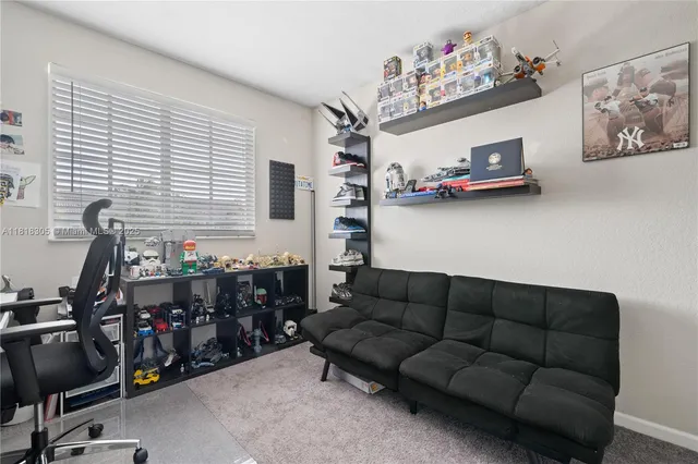 a living room with furniture a air conditioner and a window