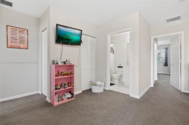 a room with painting and a lamp