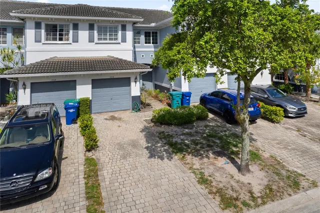 a view of a car park in front of a house