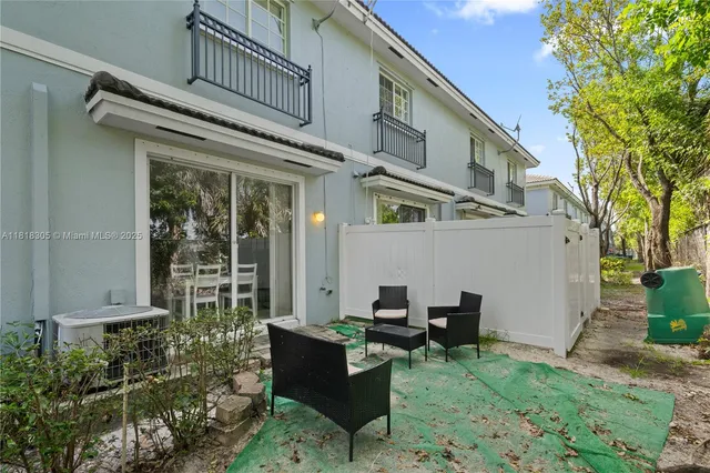 a backyard of a house with outdoor seating