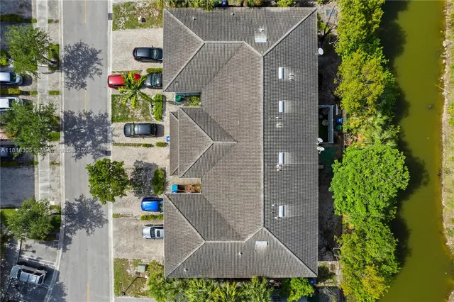 an aerial view of a house with a yard and garden