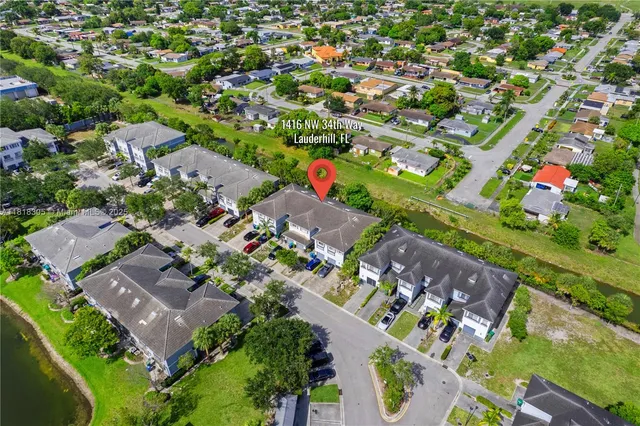 an aerial view of residential houses with outdoor space