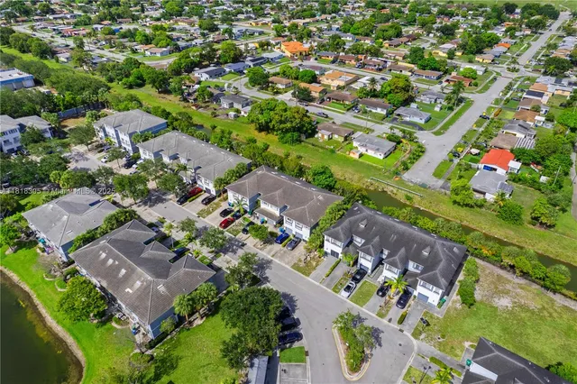 an aerial view of residential houses with outdoor space