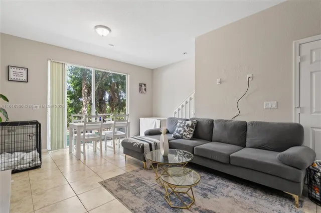 a living room with furniture and a large window