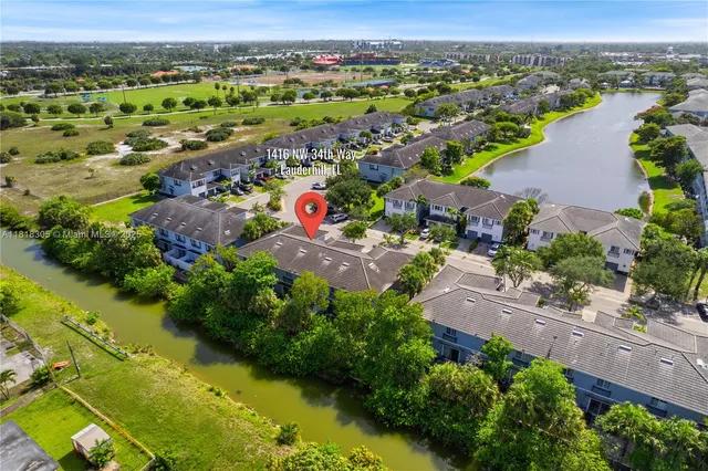 an aerial view of residential houses with outdoor space