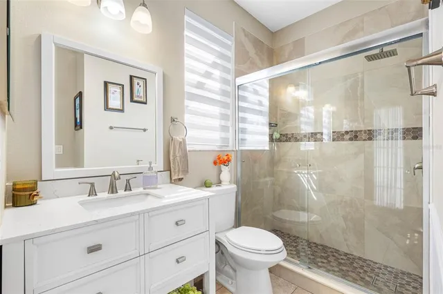 a living room with furniture and a flat screen tv with wooden floor