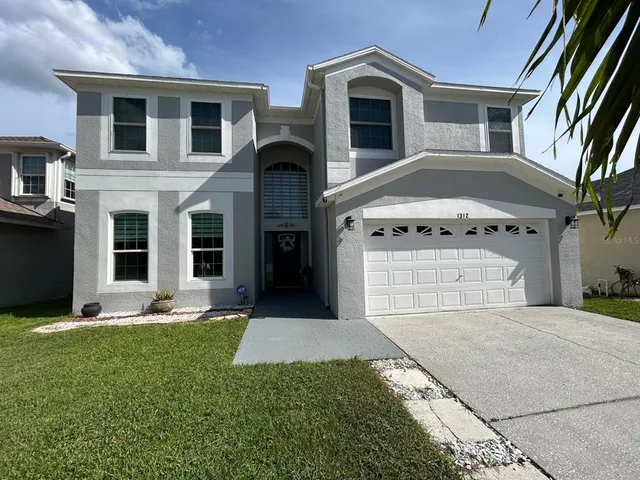 a living room with furniture a dining table and paintings on the wall
