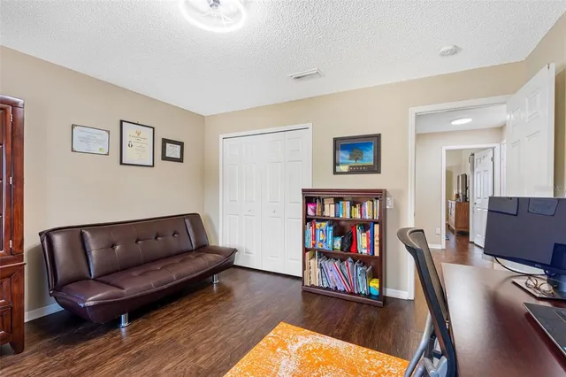 a view of a house with pool and sitting area