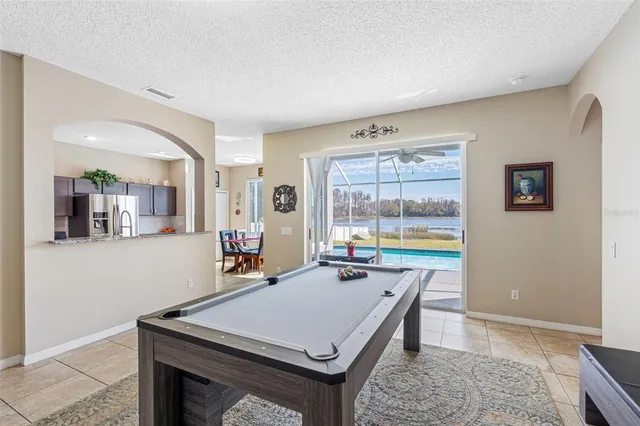 a living room with furniture and a floor to ceiling window
