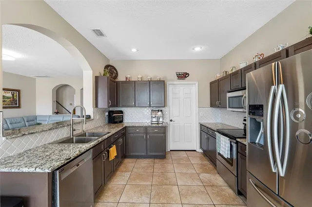 a bathroom with granite countertop a sink and a mirror