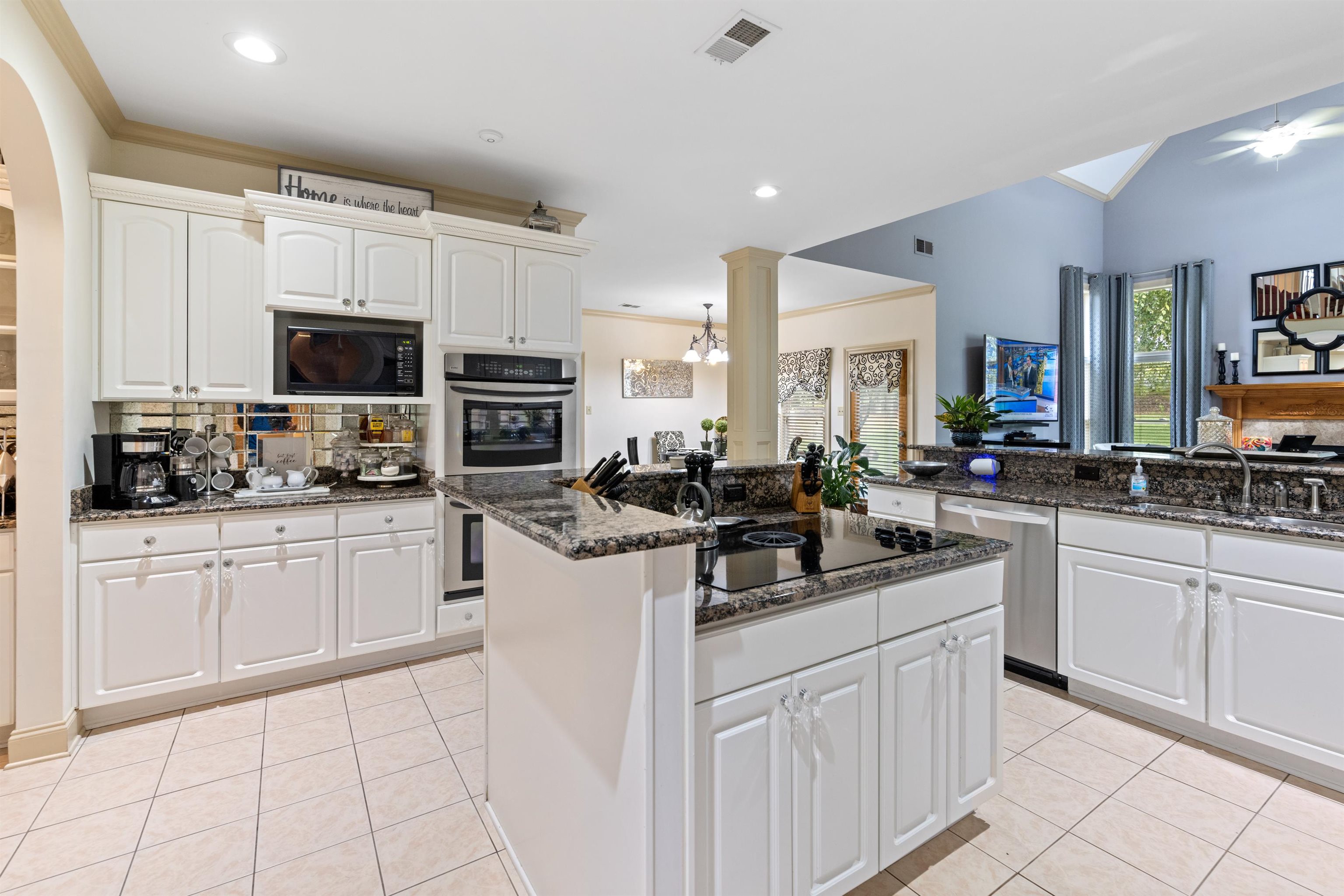 11241 Latting Road Eads, TN 38028 - Photo 10 of 31 Kitchen with dark stone countertops, white cabinets, light tile patterned floors, and black appliances