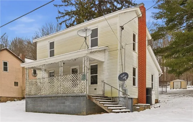 a front view of a house with fence