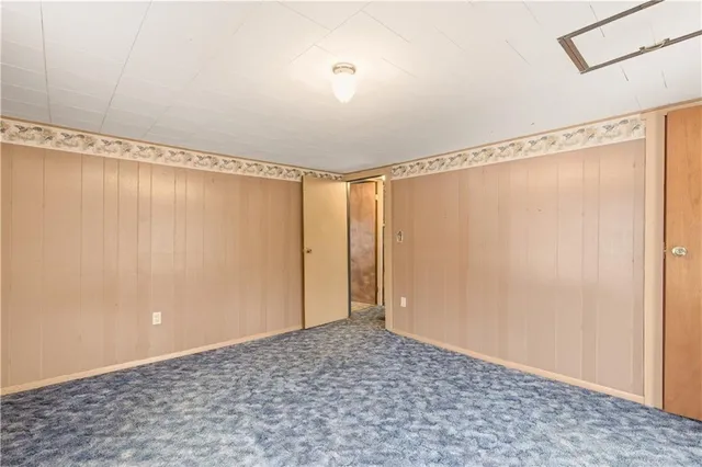a view of a room with wooden floor and glass window