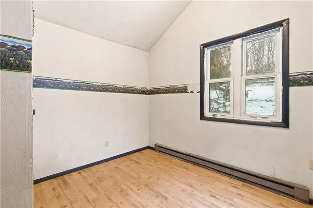a view of a room with wooden floor and windows