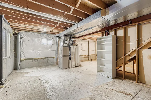 a view of a white house with a yard and large tree
