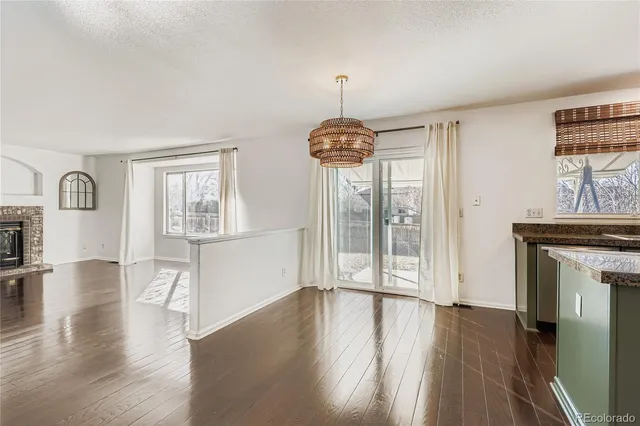 a view of empty room with wooden floor and fireplace