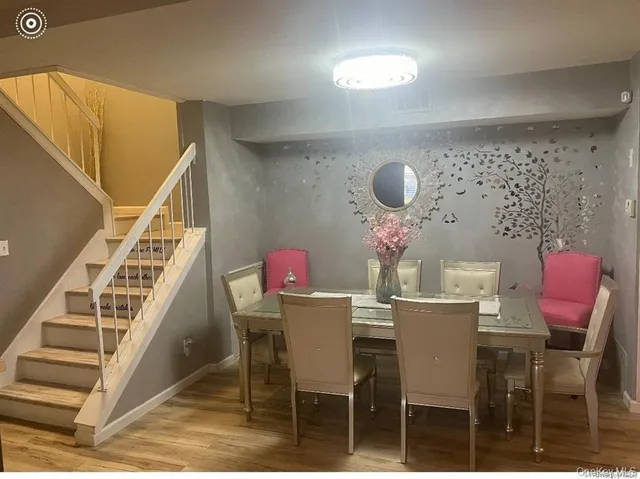 a dining room with furniture and wooden floor