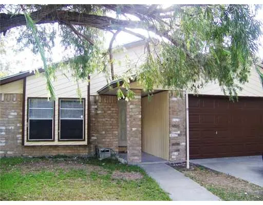 front view of a house with a tree