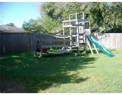 a view of a chair and table in the garden