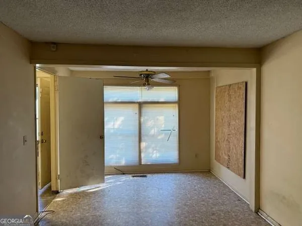 an empty room with windows and closet