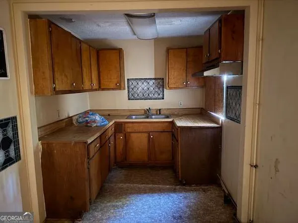 a kitchen with stainless steel appliances granite countertop a stove a refrigerator and a sink