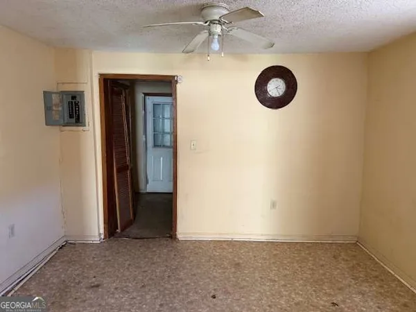 an empty room with a fan