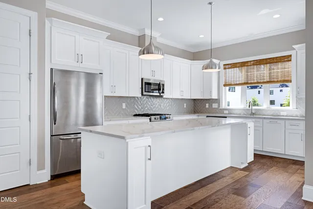 a kitchen with kitchen island white cabinets and white appliances