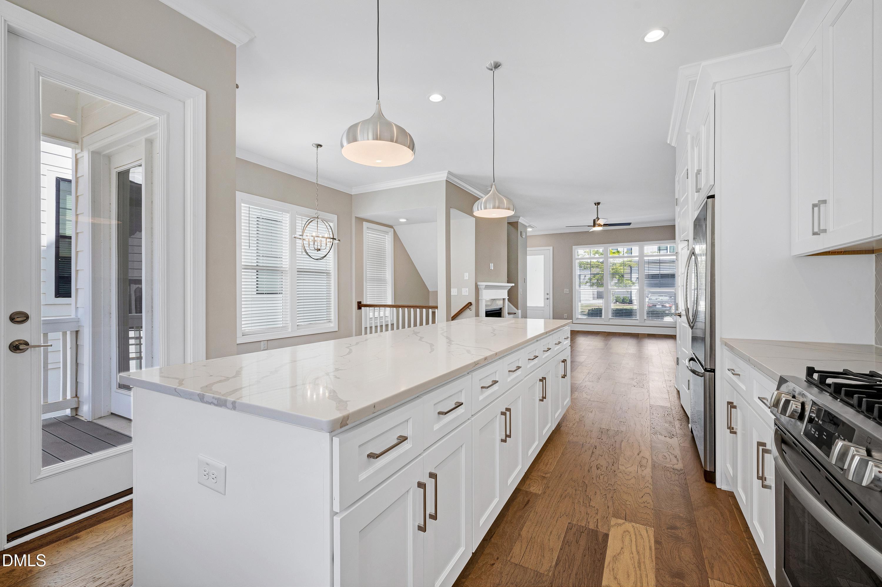 4909 Madone Drive Raleigh, NC 27606 - Photo 14 of 48 a kitchen with stainless steel appliances granite countertop a sink a stove and a wooden floors