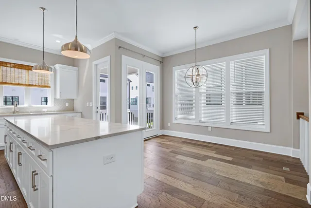 a kitchen with granite countertop a sink and dishwasher with wooden floor