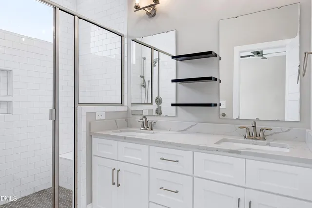 a bathroom with a double vanity sink and a mirror