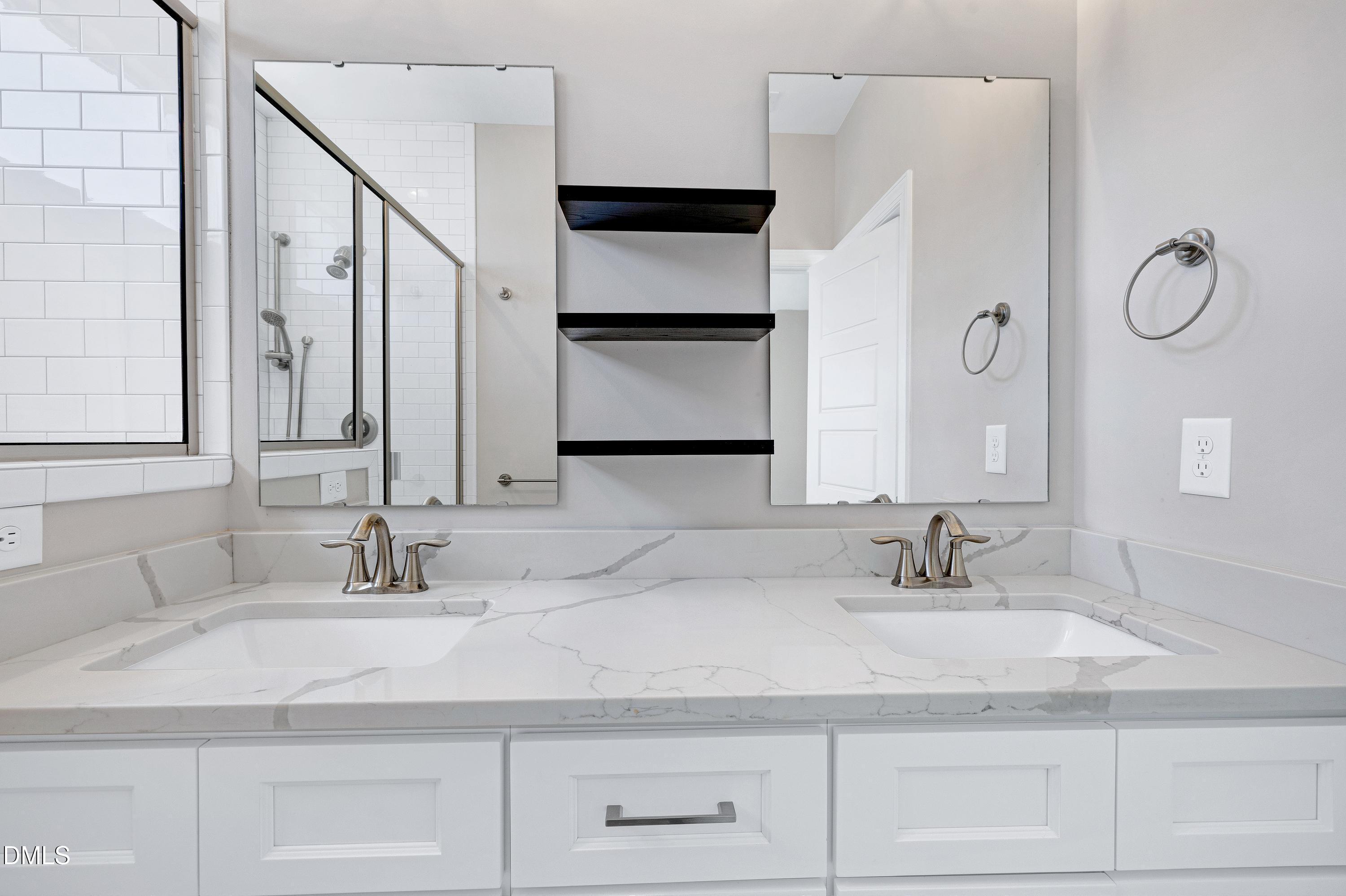 4909 Madone Drive Raleigh, NC 27606 - Photo 24 of 48 a bathroom with double vanity sinks and a mirror