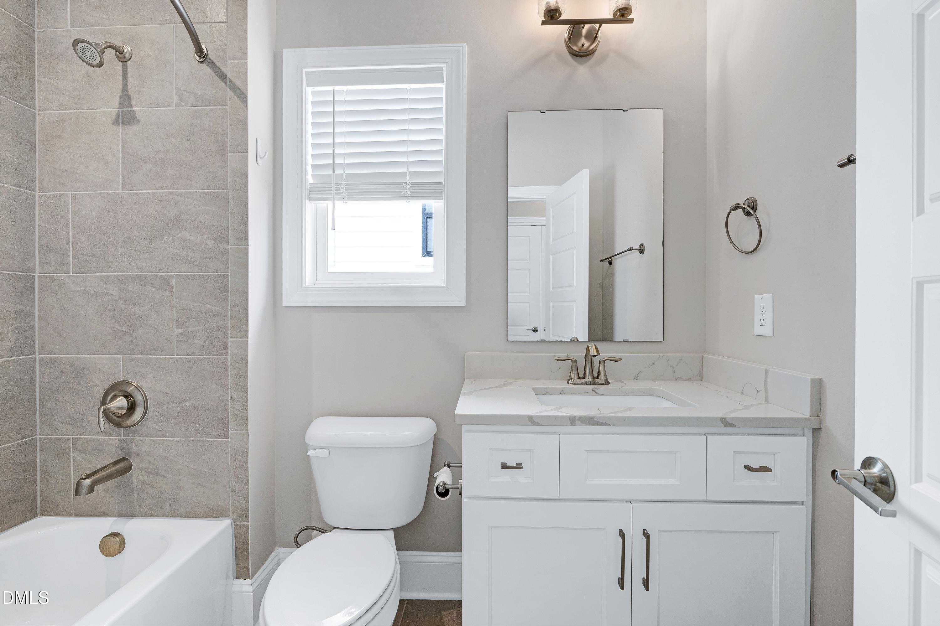 4909 Madone Drive Raleigh, NC 27606 - Photo 28 of 48 a bathroom with a sink toilet tub and shower