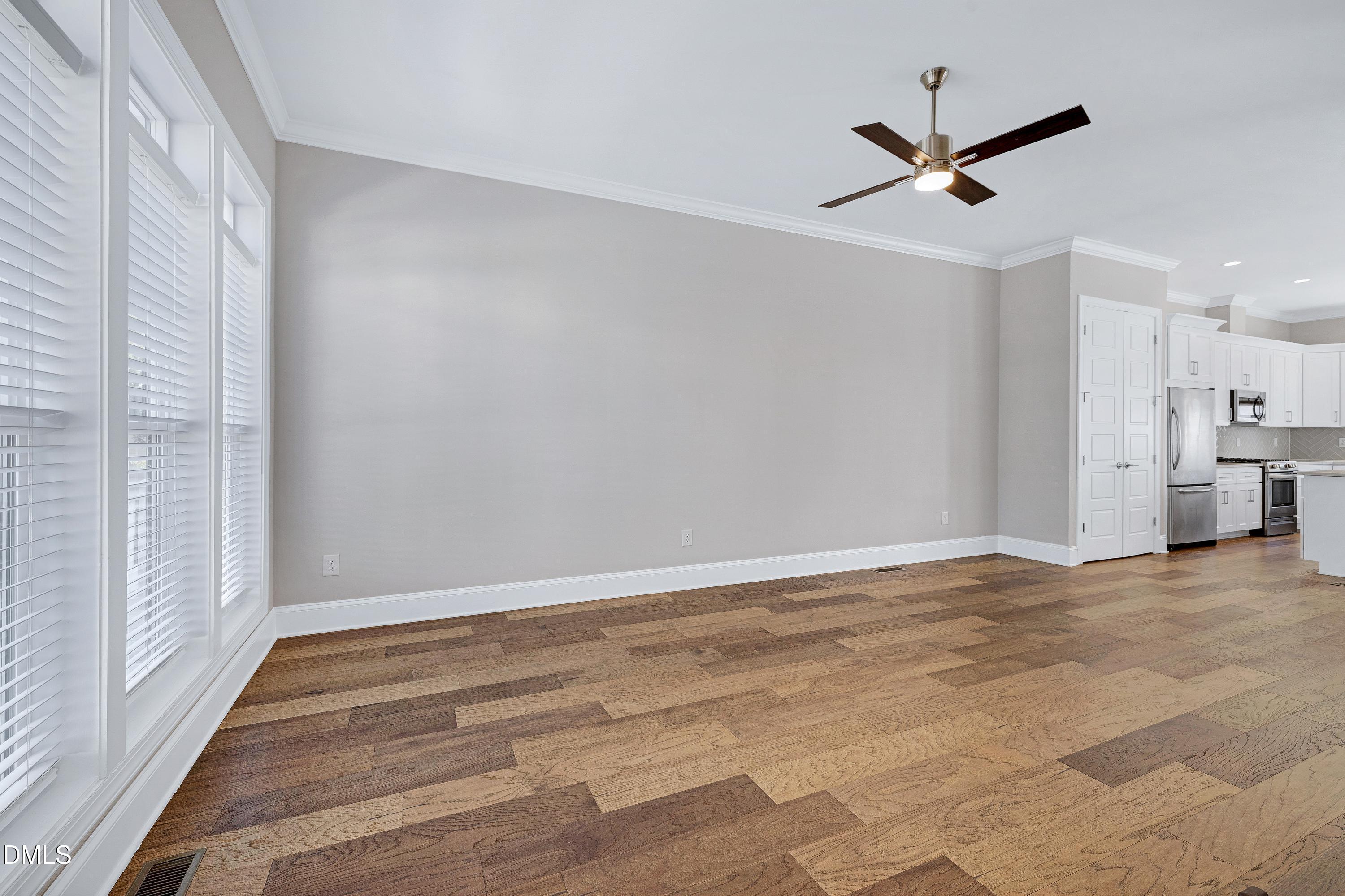 4909 Madone Drive Raleigh, NC 27606 - Photo 3 of 48 a view of a livingroom with a ceiling fan and window